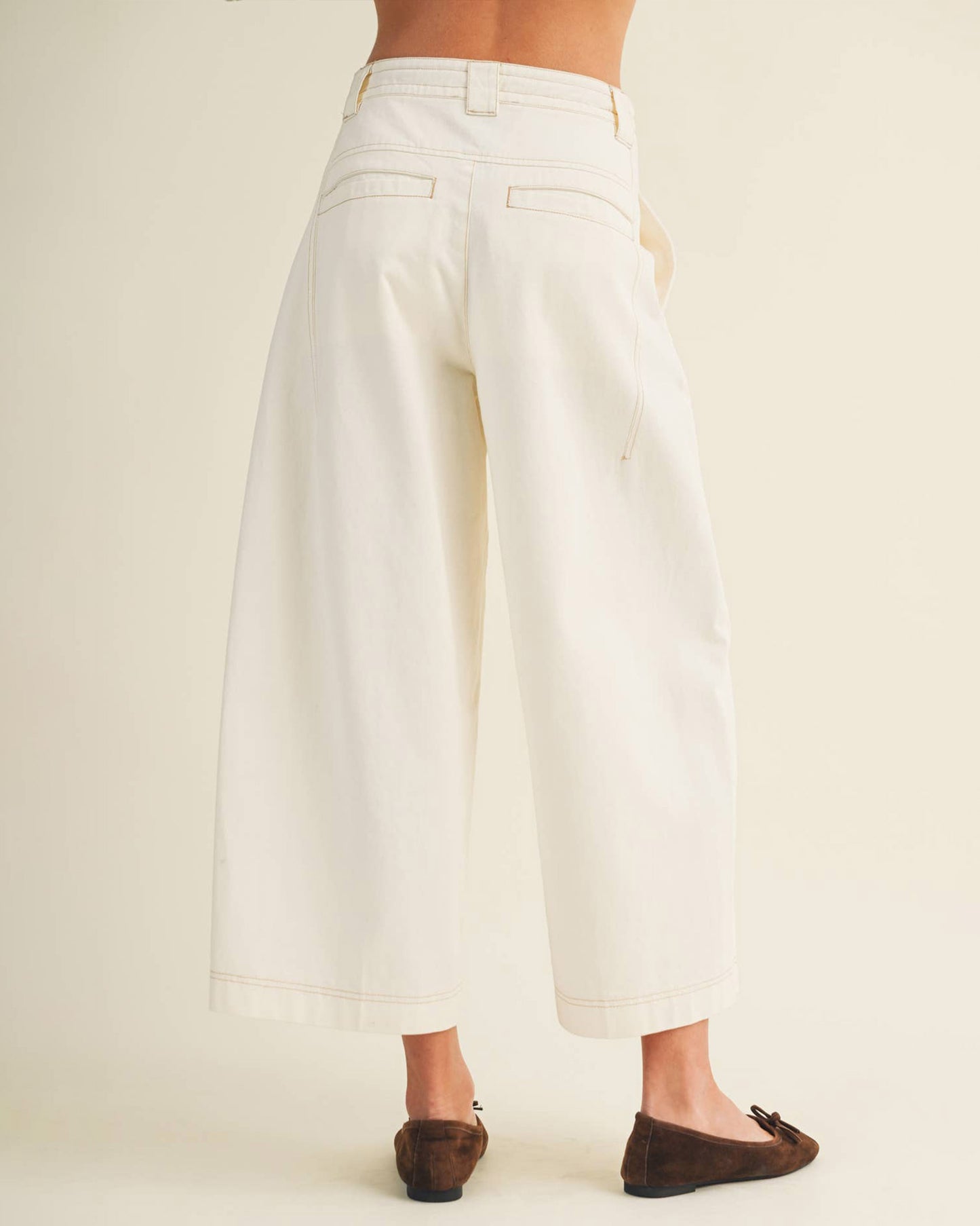 White wide-leg pants worn by a person on a plain background