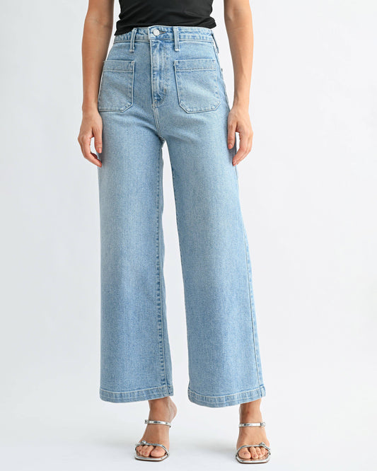 Light blue jeans worn by a person on a white background