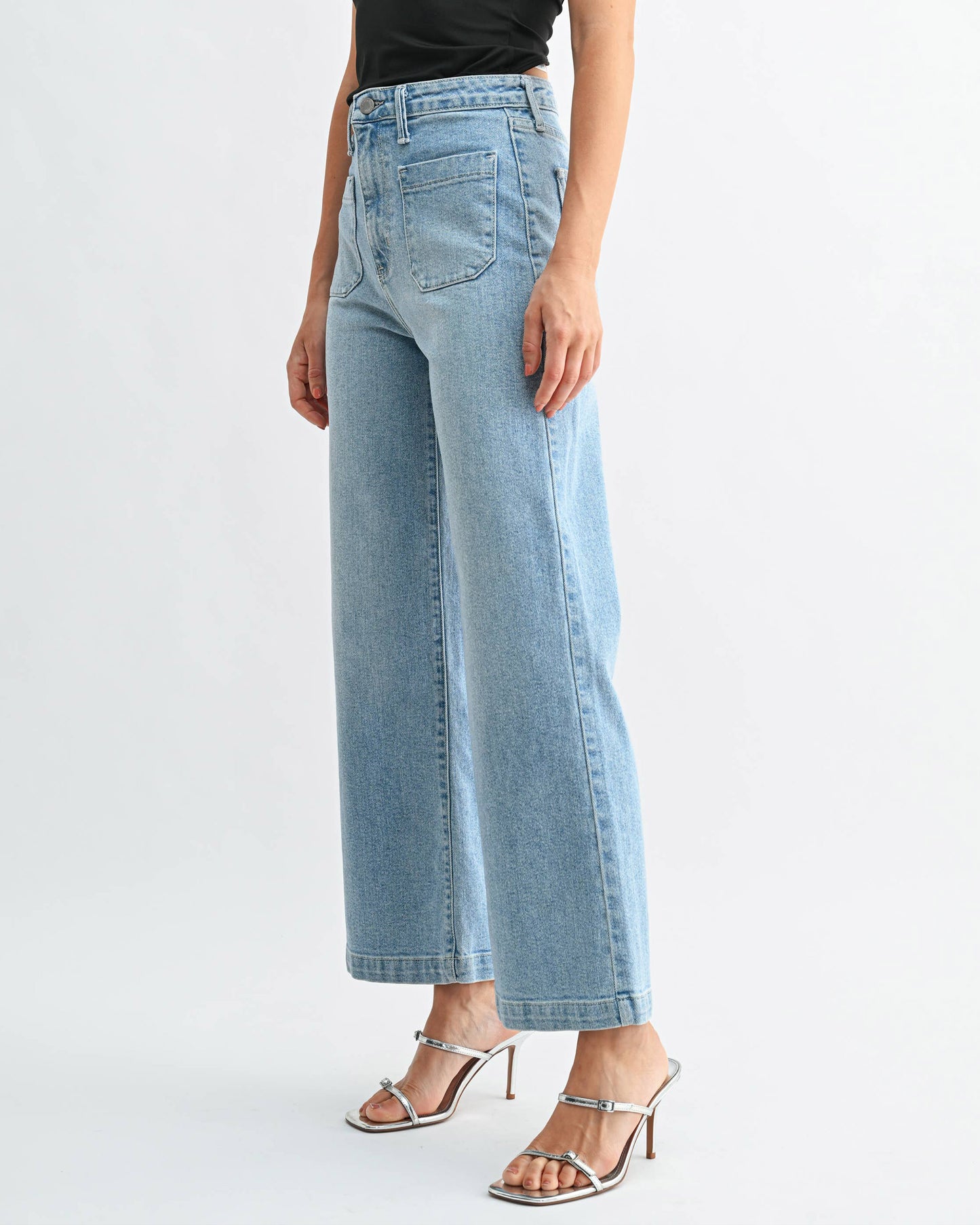 Light blue jeans worn by a person on a white background