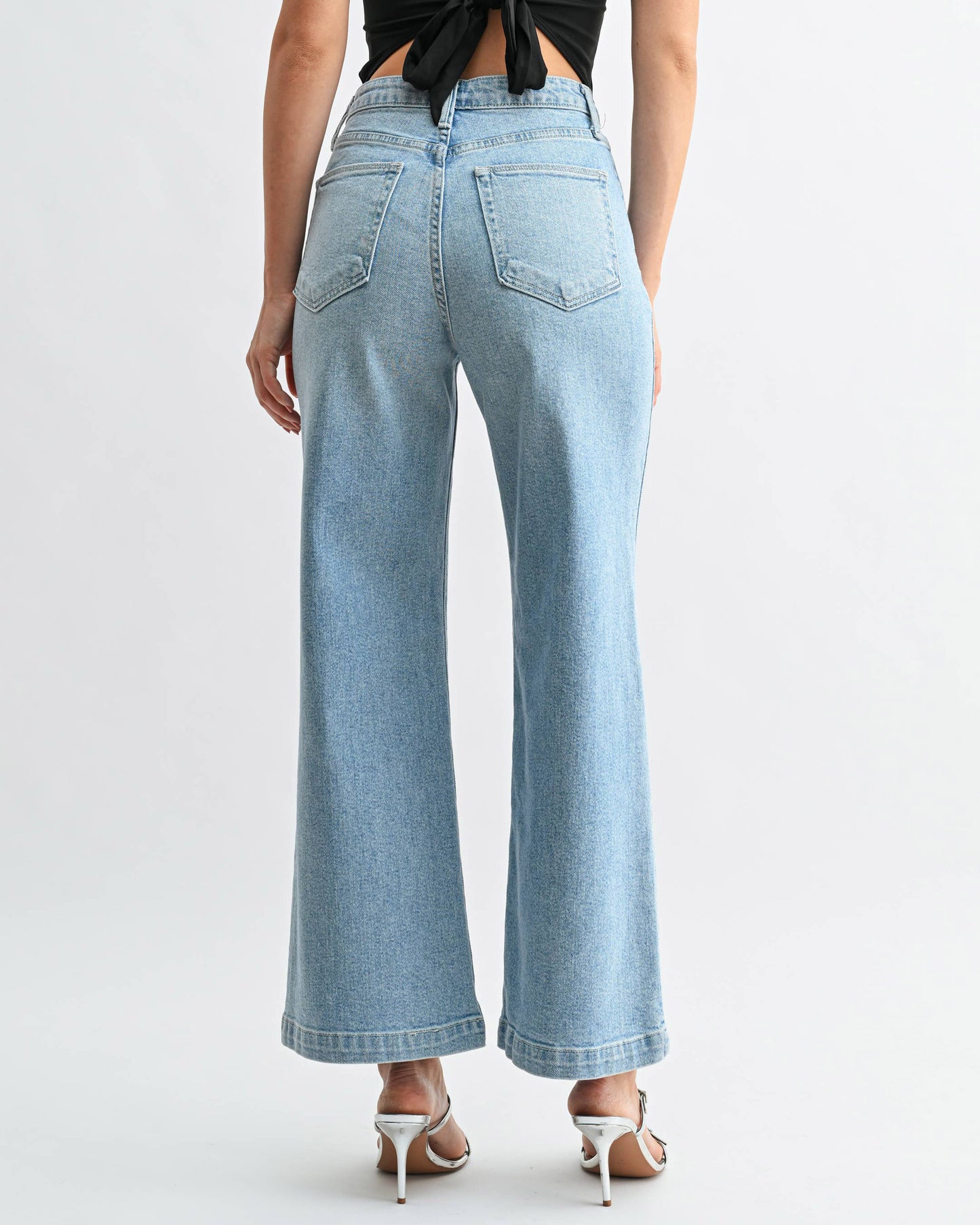 Light blue jeans worn by a person on a white background