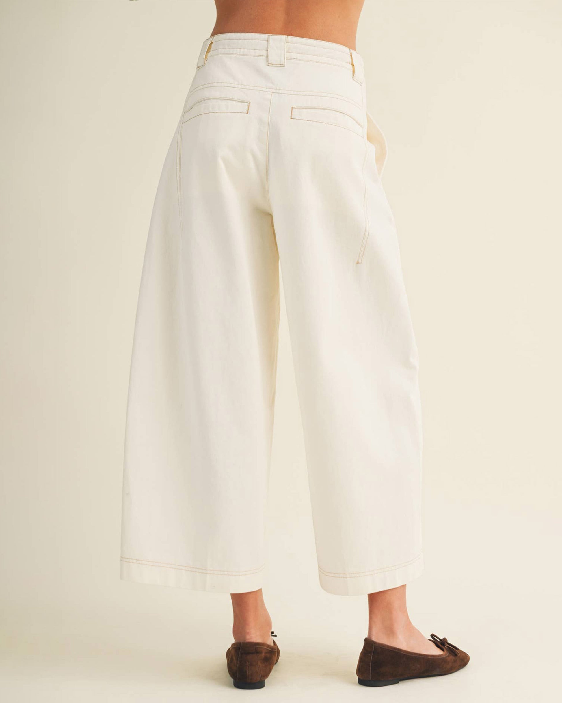 White wide-leg pants worn by a person on a plain background