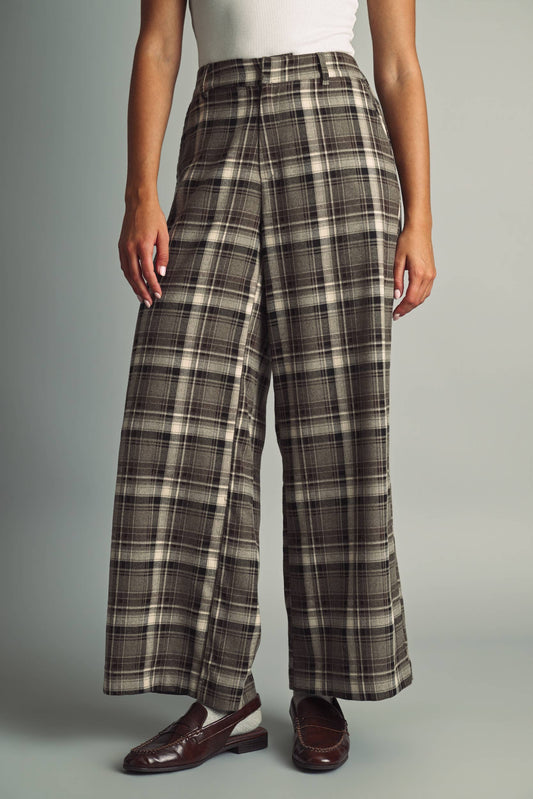 Women's brown, black, and beige plaid high-waisted pants with a tailored wide leg silhouette and fitted waistband.