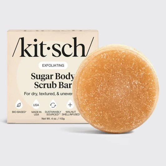 Exfoliating sugar body scrub with natural sugar granules and walnut shell exfoliants for softer, smoother skin.