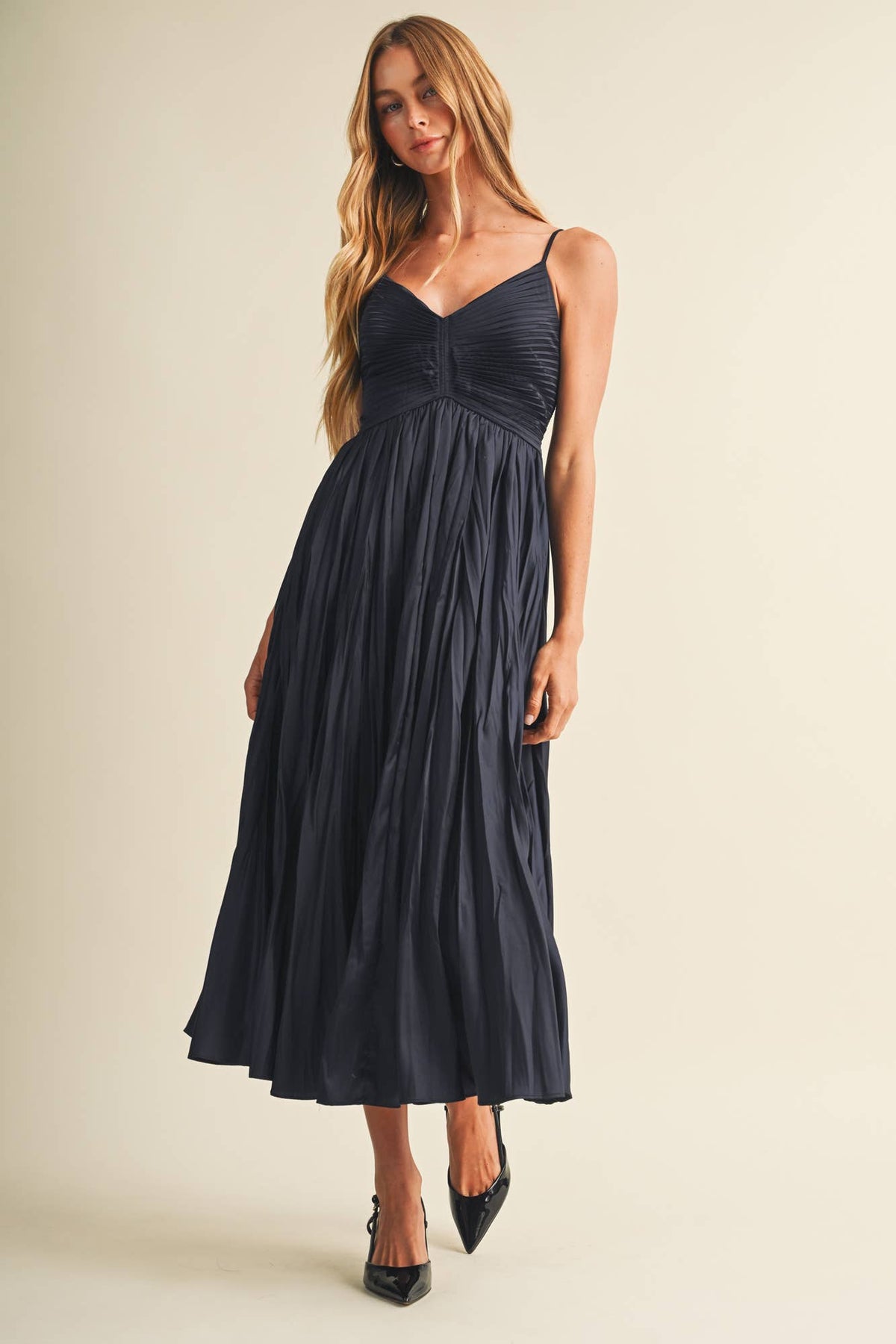 Women's smocked poplin midi dress featuring a ruched bodice, deep V-neckline, adjustable straps, and flowing A-line skirt.